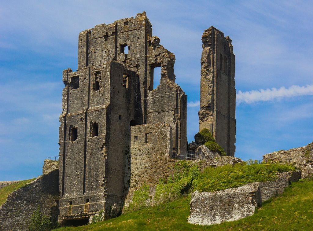 Explore the ancient ruins of Corfe Castle, a historic landmark in England, showcasing medieval architecture.